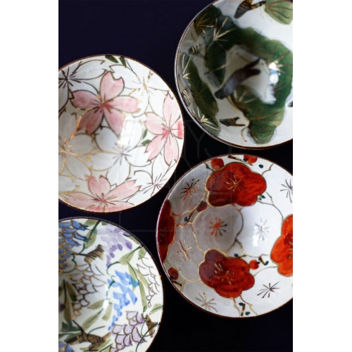 Earth-toned sake cups and flask with rough textures, evoking the quiet beauty of imperfection