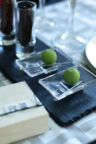 Matcha chocolate truffles arranged on a dish, paired with a glass of chilled junmai ginjo sake.